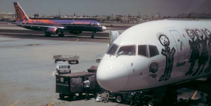 America West 757-2S7, N907WA Phoenix Suns taxis past N902AW Teamwork at Phoenix Sky Harbor on July 6, 1997