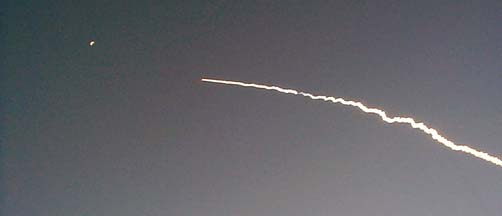 The second set of the Delta-II's solid fuel boosters ignite on December 7, 2001